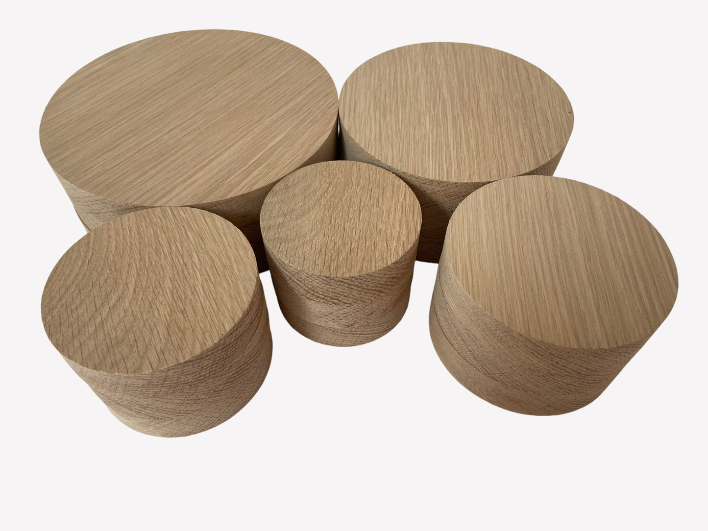 Different sized round oak wood blanks arranged together, ideal for crafting and engraving.
