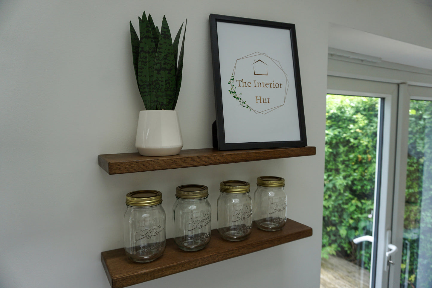 Oak Floating Shelf - 12cm Deep x slim 2.2cm Thick - Smooth Finish - mounted to a masonry wall displaying decorative items The Interior Hut