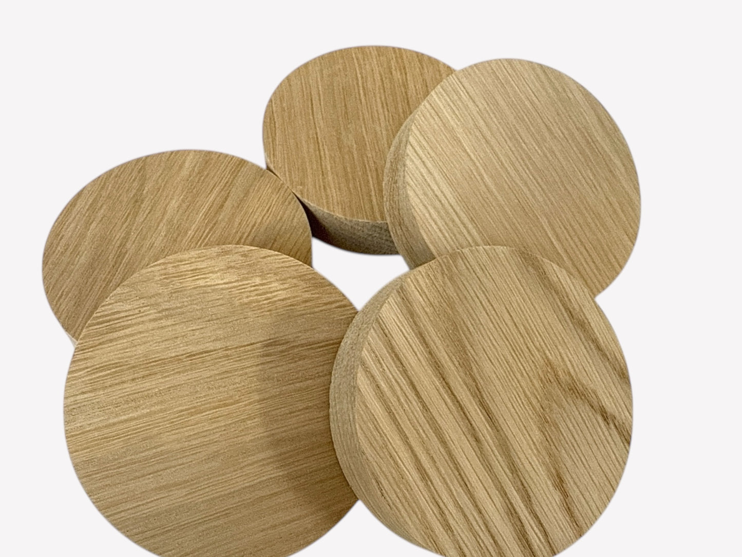 Set of five identical-size solid oak wooden circle blanks with smooth finish and natural grain.