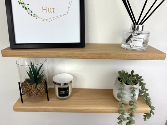 Slim oak floating shelf wall mounted displaying decorative items