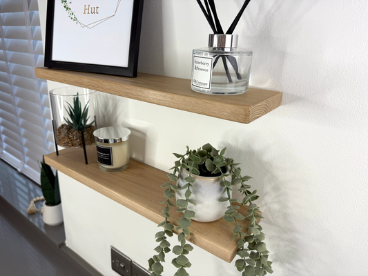 SIde view of Slim oak floating shelf wall mounted displaying decorative items