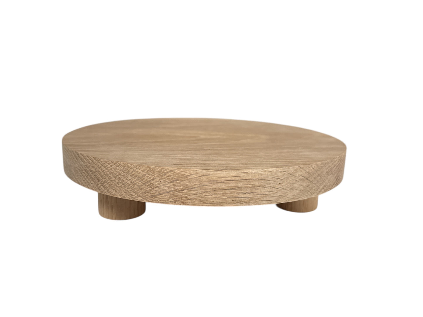 Round wooden display table on a white background
